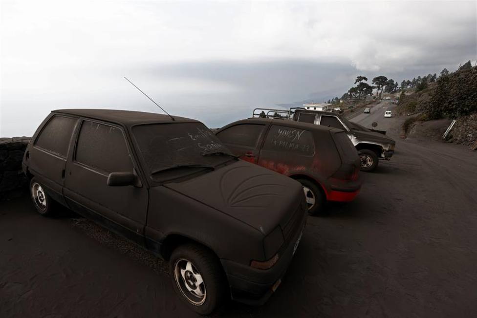Varios vehículos completamente cubiertos de ceniza volcánica en La Palma