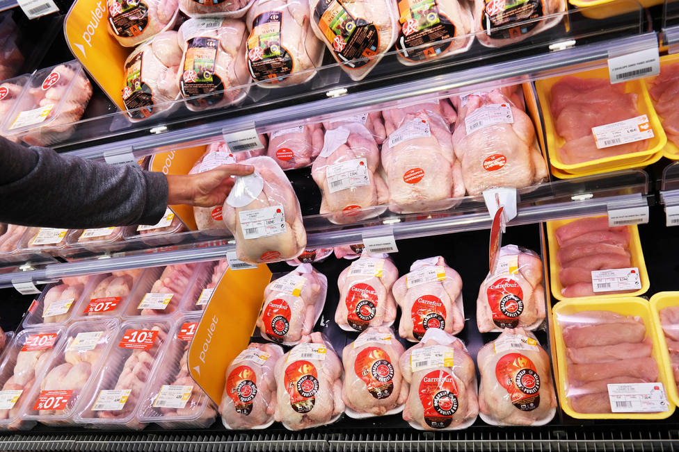 Customer selecting packaged chicken meat.